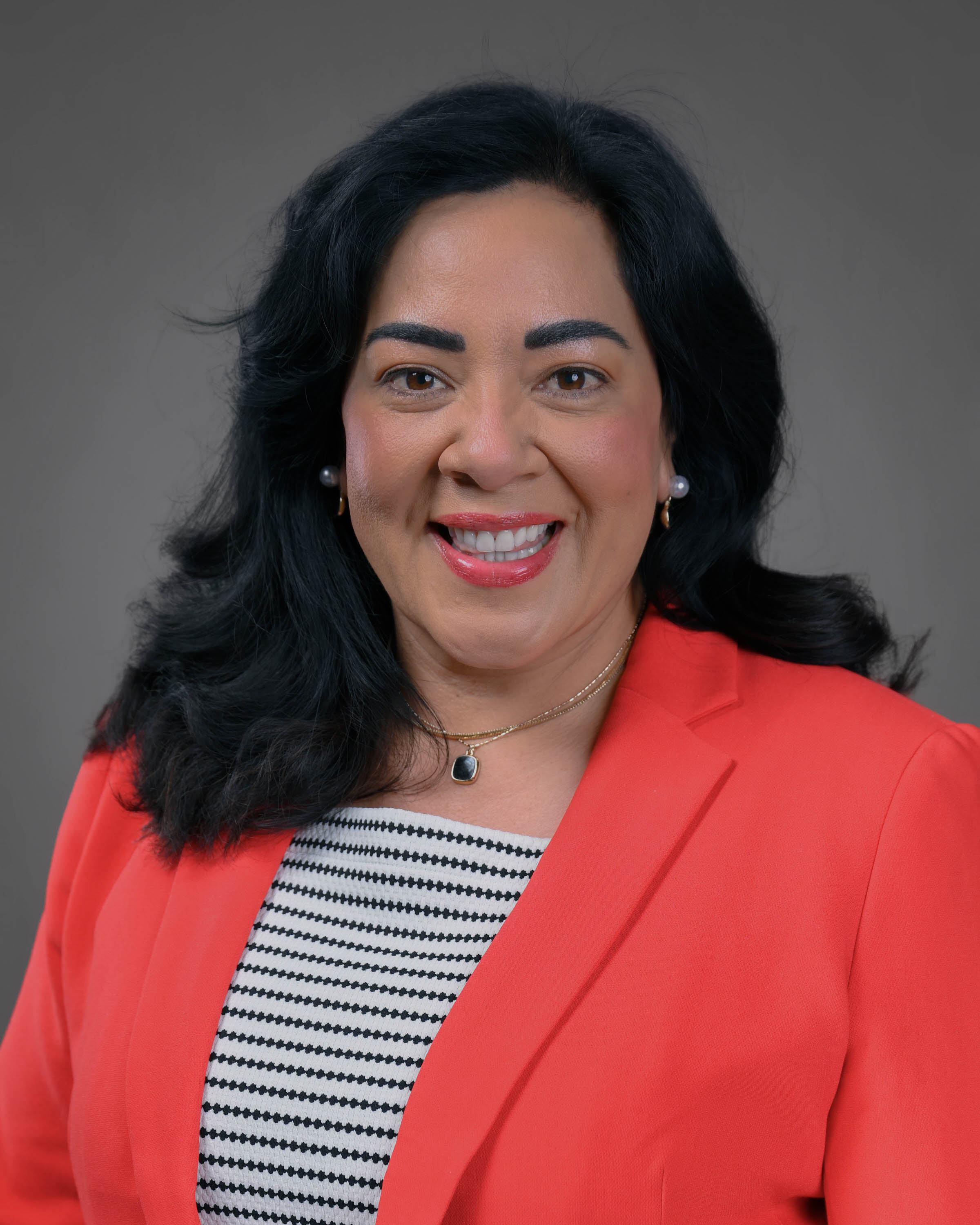 Smiling woman with long dark hair in a red jacket